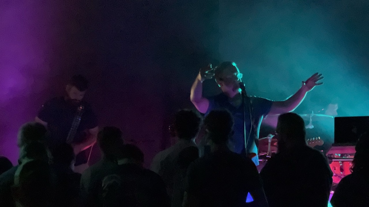Live performance with purple and teal stage lighting
