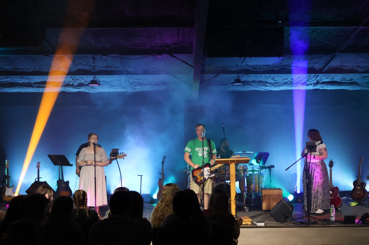 Worship band onstage with colorful programmed lighting